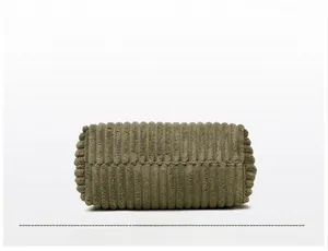 Detailed close-up of dark green corduroy tote bag bottom with neat stitching