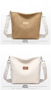 Detail of corduroy tote bags in yellow and white with geometric woven wide shoulder straps