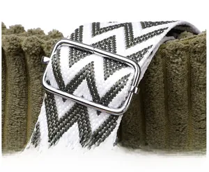 Detail of adjustable wide woven zigzag shoulder strap with silver metal buckle on tote