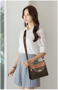 Detail of multi-layer zipper crossbody bag with vintage pattern jacquard strap