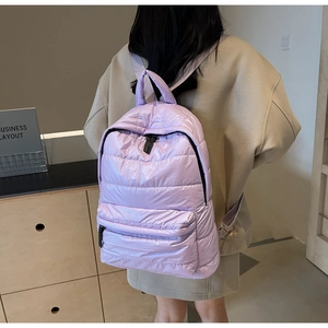 Rear view of a lilac padded backpack featuring quilted nylon and lightweight design