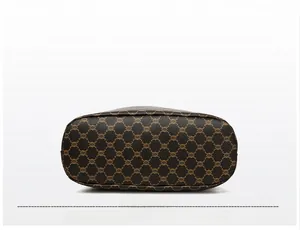 Detail view showing the oval reinforced bottom of the monogrammed crossbody bag