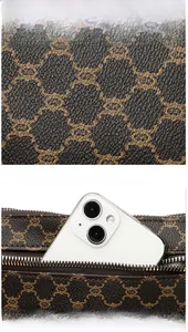 Macro detail of brown monogram bag showing the back zipper pocket for phone storage