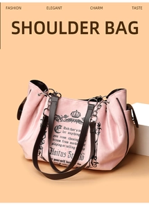 Detail of pink vintage shoulder bag with retro graphic print and metal chain strap