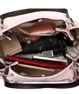Spacious interior of pink suede tote bag showing storage for umbrella and cosmetics