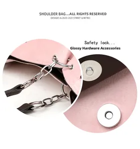 Detail of pink velvet shoulder bag with polished silver chain and magnetic metal clasp