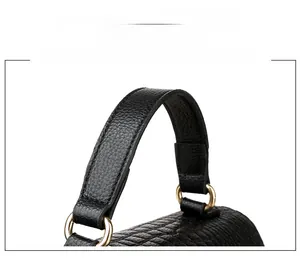 Detail of black crocodile-embossed PU bag showing gold metal rings and sturdy handle stitching