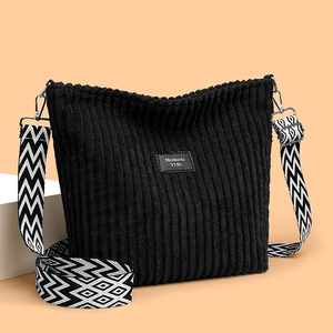 Black corduroy tote bag with ethnic geometric wide shoulder strap and woven patch
