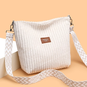 Large beige corduroy tote bag with textured finish and geometric patterned shoulder strap