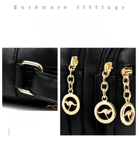 Close-up of black lychee grain leather crossbody bag with pale gold hardware and kangaroo zipper