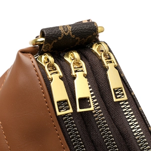 Three-layer brown monogram shoulder bag featuring premium gold-tone zippers and leather trim