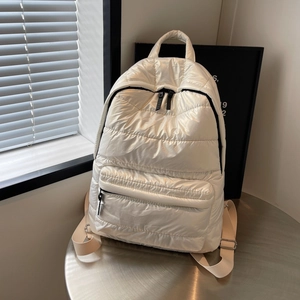 Chic quilted puffer backpack in off-white finish with glossy fabric and top handle