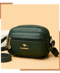 Detail of dark green textured leather crossbody bag with gold kangaroo logo and zipper