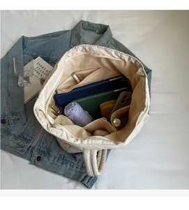 Interior view of the canvas tote bag showing large capacity and multi-pocket organization