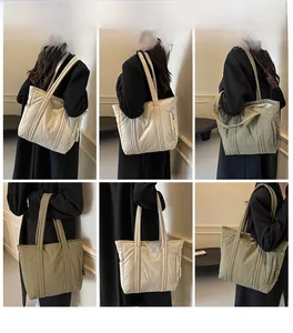 Detailed views of cream and olive green quilted canvas tote bags with padded straps