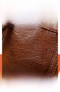 Detail of dark brown waterproof PU leather with soft texture and neat stitching