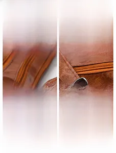 Detailed shot of silver plated metal hardware and brown litchi texture leather handbag