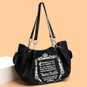 Retro black canvas tote bag with gothic print and silver chain strap shown in a side view