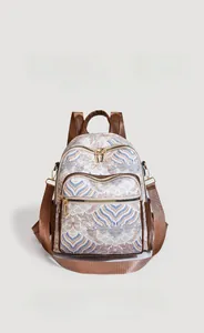 Detail of vintage canvas backpack with ethnic wave pattern and brown leather trim