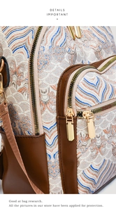 Detail of jacquard fabric wave texture and gold metal zippers on a vintage backpack
