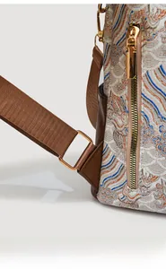 Detail of Chinese style backpack featuring wave patterns and premium gold zipper hardware