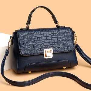Navy blue faux leather handbag with crocodile pattern texture and gold buckle