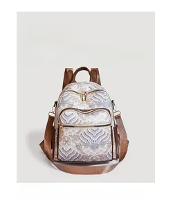 Detail of vintage beige backpack with blue wave patterns and brown leather straps