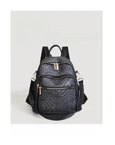Detail view of black vintage backpack with golden traditional Chinese wave patterns