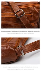 Detail of adjustable shoulder strap and durable silver metal hardware on brown leather bag