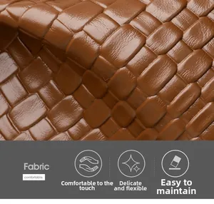 Close-up of brown woven texture fabric detail on a soft leather shoulder bag for women