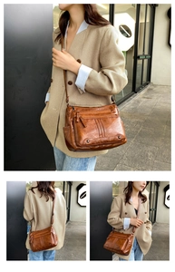 Close-up of vintage brown leather shoulder bag with multiple zipper pockets and adjustable strap
