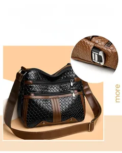 Detail of woven leather crossbody bag showing multiple zip pockets and car key storage