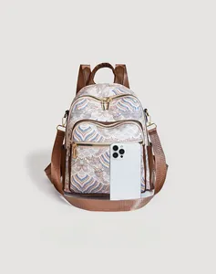 Detail of vintage cloud pattern backpack with smartphone for scale comparison