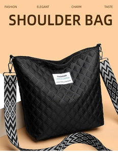 Detail of black quilted shoulder bag featuring fashion label and geometric patterned strap