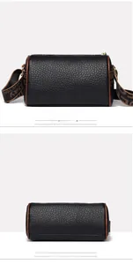 Détails macro du sac cylindrique en cuir noir avec bordure marron et large bandoulière