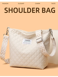 Close-up of beige quilted shoulder bag featuring fashion label and jacquard strap