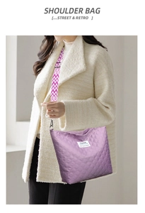 Detail of purple quilted shoulder bag featuring vintage geometric strap and brand label