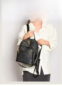 Detail of vintage Chinese style backpack with golden wave texture and gold hardware