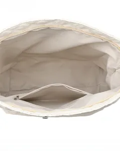 Internal view of quilted shoulder bag showing spacious main compartment and zipper pocket