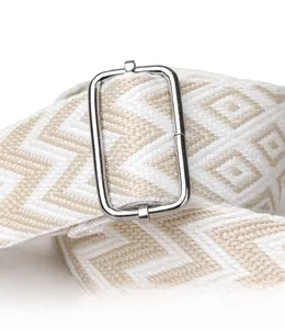 Close-up of woven adjustable shoulder strap with silver buckle for quilted bags