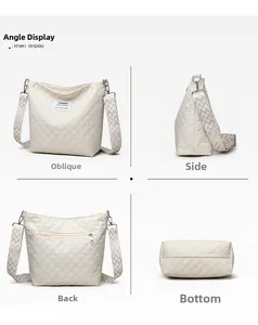 Detail view of khaki quilted crossbody bag with diamond stitching and rear zipper pocket
