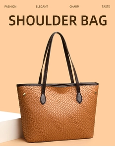 Detail of woven brown tote bag showing textured surface and metallic gold rivets