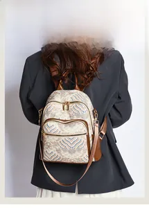 Detail view of ethnic print multi-pocket backpack with brown leather base for women