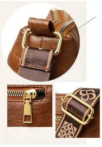 Detail of brown textured leather bag showing gold hardware and printed wide strap