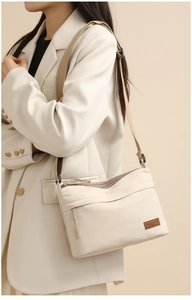 Detail of waterproof nylon crossbody bag with adjustable strap and brand logo patch
