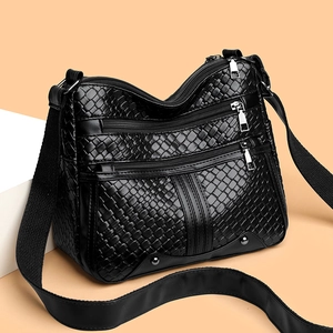 Women's black woven faux leather crossbody bag with multi-pocket design and adjustable strap