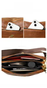 Brown multi-pocket crossbody bag with triple compartments and wide woven strap details