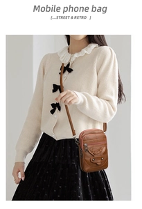Detail view of retro brown textured leather crossbody phone bag with braided strap and rivets