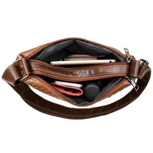 Brown woven leather shoulder bag with double zipper compartments and spacious interior
