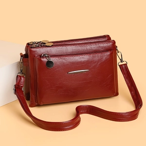 Deep red multi-layer crossbody bag with textured faux leather and adjustable strap